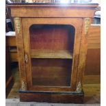A Victorian walnut pier cabinet, with ebonised and crossbanded top, gilt mounts and a glazed door,