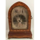 A 19th century arched mantel clock, the striking movement with silver dial and two subsidiary dials,