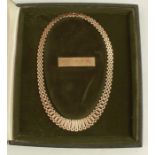 A cased 9ct gold necklace, of flat link, weight 26g, the case with presentation plaque, For