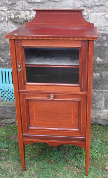 An Edwardian mahogany music cabinet, with part glazed door and pull out canterbury below, width