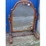 A 19th century walnut framed dressing table mirror, the arched mirror supported by a pair of