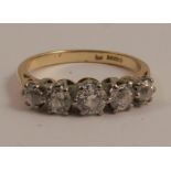 An 18 carat gold five stone diamond ring, the graduated old brilliant cuts totalling approximately
