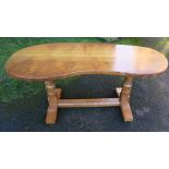 A Robert Mouseman Thompson burr oak kidney shaped table, raised on octagonal supports, 65ins x