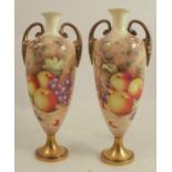 A pair of Royal Worcester vases, the fronts painted with fruit to a mossy background by Freeman,