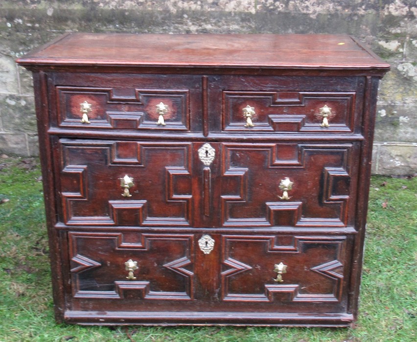 A 17th century style moulded front chest, of two short drawers over three long drawers, width