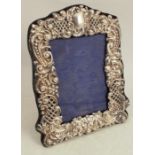 A silver mounted photograph frame, with pierced and embossed decoration, Birmingham 1906, aperture