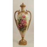 A Royal Worcester two handled pedestal vase, decorated with roses by Roberts, shape number 1957,