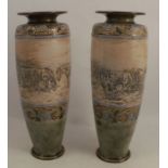 A pair of Royal Doulton stoneware vases, decorated with an incised band of horses and cattle by