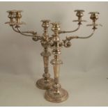 A pair of Sheffield plate candelabra, with three sconces and two scroll arms, with leaf and flower