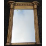 A gilt framed wall mirror, with columns to the sides and balls to the frieze, overall dimensions