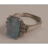 An aquamarine and diamond ring, the white mount stamped '18K', the step cut stone approximately 11.