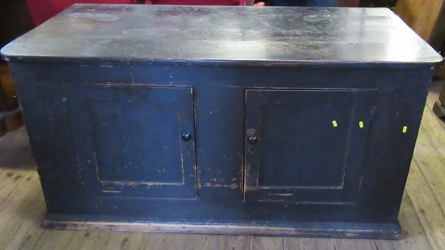 A 19th century painted and stained cupboard base, possibly pine, having two cupboard doors and a