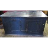A 19th century painted and stained cupboard base, possibly pine, having two cupboard doors and a