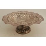 A silver pedestal bonbon dish, with pierced wavy edge and gadrooned band to C scroll centre, the