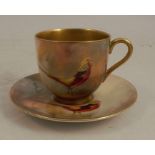A Royal Worcester cabinet cup and saucer, decorated with an Asiatic pheasant in landscape by