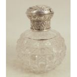 A cut glass dressing table scent bottle, of bulbous form, with silver mount, the hinged cover