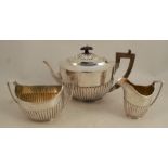 A silver three piece tea set, with gadrooned lower body, London 1887, weight 37oz all in