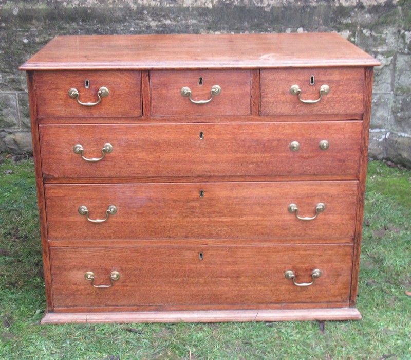 An oak chest, of three short over three long drawers, width 39.5ins x depth 21.75ins x height 32.