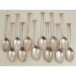 Twelve Elkington & Co silver dessert spoons, with scroll terminals, six Birmingham 1902 and six