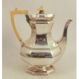 A silver coffee pot, of octagonal baluster form, with ivory finial and handle, London 1908, maker