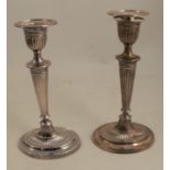 A pair of silver candlesticks, of oval form with fluted decoration, Sheffield 1896, height 8.