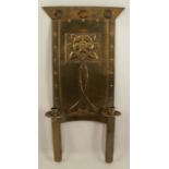An Arts and Crafts style brass double candle holder, with flower decoration, height 23.5ins, width