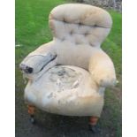 A Victorian upholstered armchair, with button back, on turned front supports, stamped C Hindley &