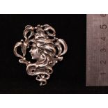 Austrian Art Nouveau circa 1910, a silver brooch with a pin fastening (untested), An elegant lady in