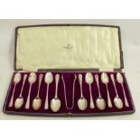 A cased set of twelve (11+1) silver teaspoons, together with matching sugar tongs, with engraved