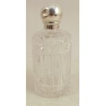 A cylindrical cut glass dressing table scent bottle, with screw off silver ball cover, London