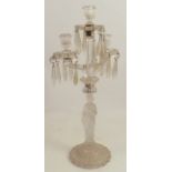 A glass candelabrum, the three candle holders, having drip trays with clear glass stoppers, the