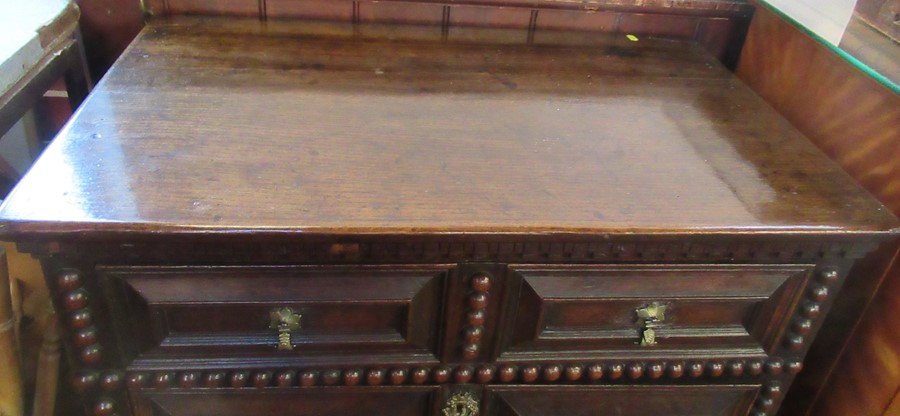 A 17th century style oak moulded front and bobbin moulded chest, of three long drawers, raised on - Image 2 of 3