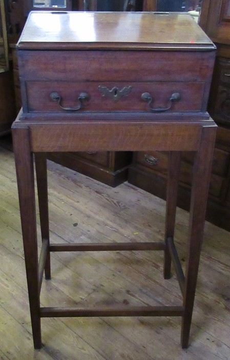 A Victorian mahogany clerk's desk or bible box, with sloping front and drawers below, raised on a