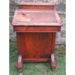 A late 19th century burr walnut davenport, having a stationery compartment, and four drawers and
