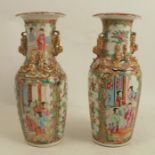 A pair of late 19th century Chinese Canton vases, decorated with figures, birds and flowers,