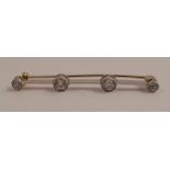 A four stone diamond bar brooch, the old brilliant cut diamonds totalling approximately 0.8