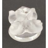 A Lalique glass paper weight, formed as four birds around a block, height 2.25ins, diameter