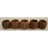 Five Robert Mouseman Thompson oak napkin rings, of octagonal form carved with mice