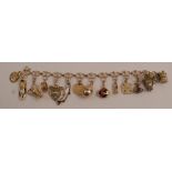 A 9 carat gold bracelet, of clover leaf style links, with fourteen charms attached, 28g gross