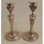 A pair of silver candlesticks, with wrythen fluted decoration, Sheffield 1886, maker Hawksworth Eyre