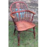 A 19th century yew wood Windsor chair, with pierced splat back, raised on turned legs, united by a