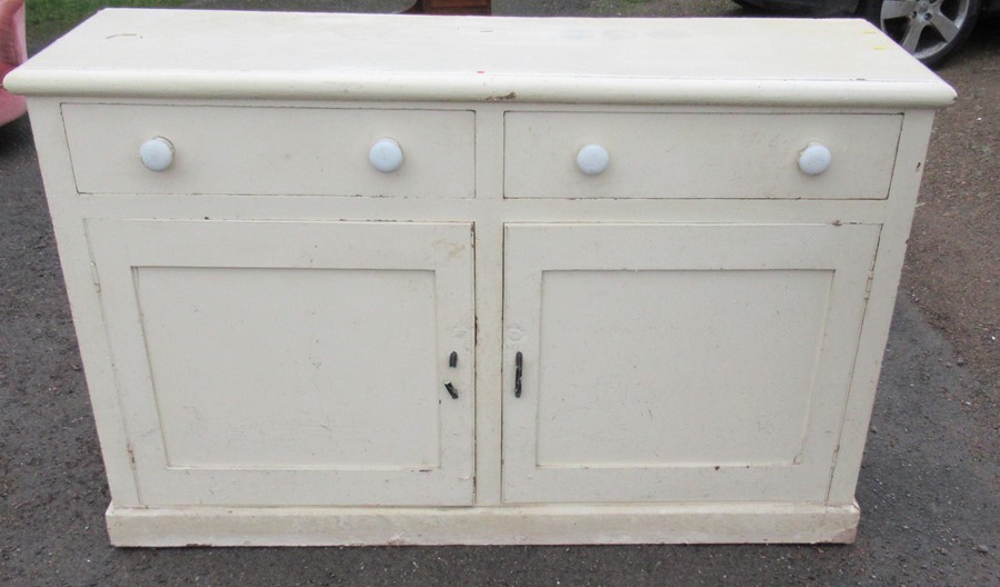 A 19th century painted pine cupboard dresser, having two drawers, with two cupboard doors below,