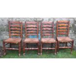 A set of four wavy ladder back North Country style dining chairs, with rush seats