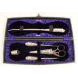 A cased hallmarked silver ladies sewing set, comprising five pieces