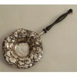 A silver tea strainer, the circular bowl embossed with pansies, with turned wooden handle, marked