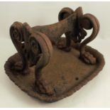 A 19th century cast iron boot scrape, with paw and scroll decoration