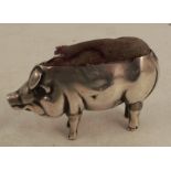 An Edwardian silver pin cushion, modelled as a pig, one ear and tail missing, Birmingham 1905