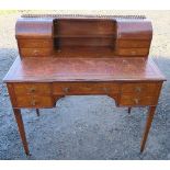 An Edwardian Sheraton revival mahogany and marquetry writing desk, with pierced brass gallery over