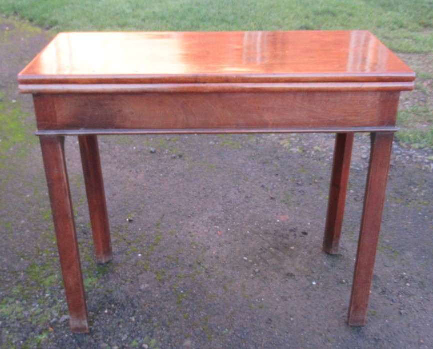 A 19th century mahogany fold over tea table, of rectangular form, with swing leg action, width