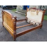 A 19th century walnut bed, with badly distressed upholstered head board and part foot board, with